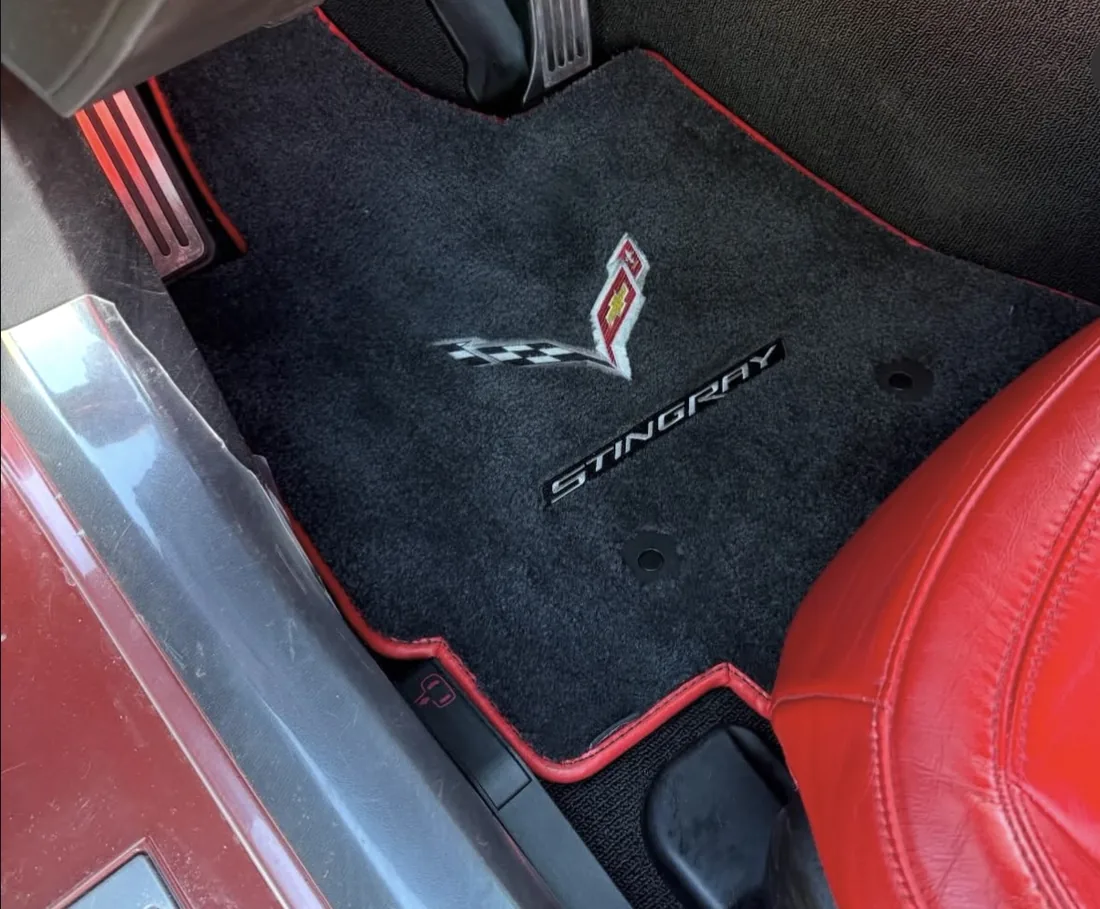 The same footwell after a Smith Detail service — carpet extracted and the mat back to black